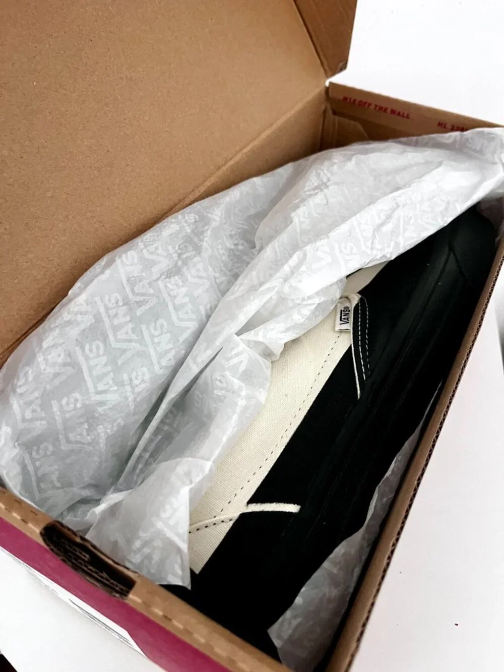 VANS  Slip-On in a black and classic CREAM colorway